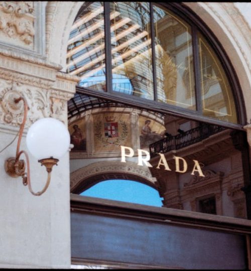 Refined facade of Prada in Galleria Vittorio Emanuele II, Milan, showcasing luxury fashion.
